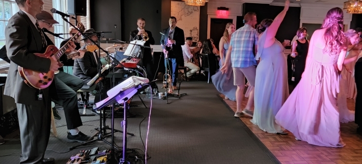 The Way Band with horns playing and people dancing at wedding