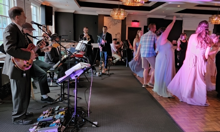 The Way Band with horns playing and people dancing at wedding