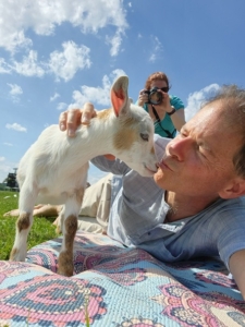 Dennis kissing goat at yoga before performing a wedding