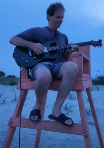 Dennis jamming in lifeguard chair at beach