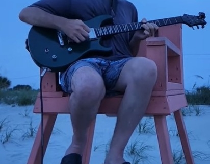 Dennis jamming in lifeguard chair at beach