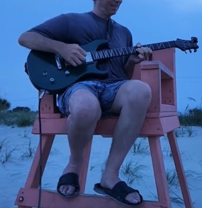 Dennis jamming in lifeguard chair at beach