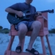 Dennis jamming in lifeguard chair at beach