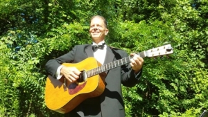 Dennis in tuxedo singing "A Thousand Years" at wedding ceremony