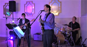 The Way Band trio with colored lights at wedding reception