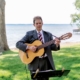 Dennis playing classical guitar at wedding ceremony on lake