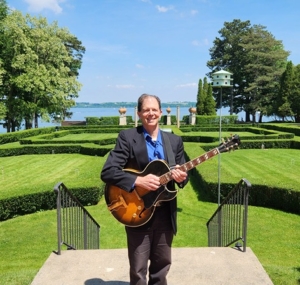 Dennis with guitar at Geneva on the Lake
