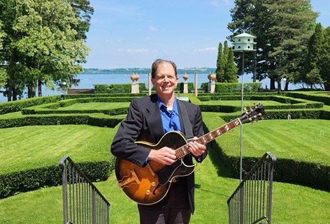 Dennis with guitar at Geneva on the Lake