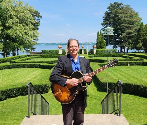 Dennis with guitar at Geneva on the Lake