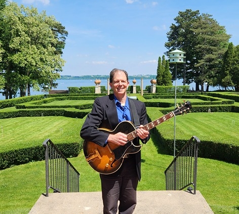 Dennis with guitar at Geneva on the Lake