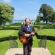 Dennis with guitar at Geneva on the Lake