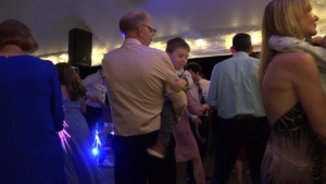 grandad holding boy on dance floor