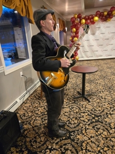 Dennis Winge playing guitar at 1244 Tavern