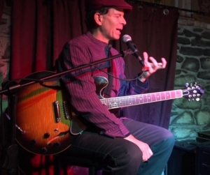 Dennis Winge lecturing and demonstrating at Art of Solo Guitar concert at Downstairs in Ithaca NY