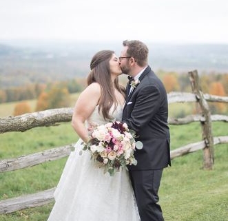 newly married couple kissing in a field