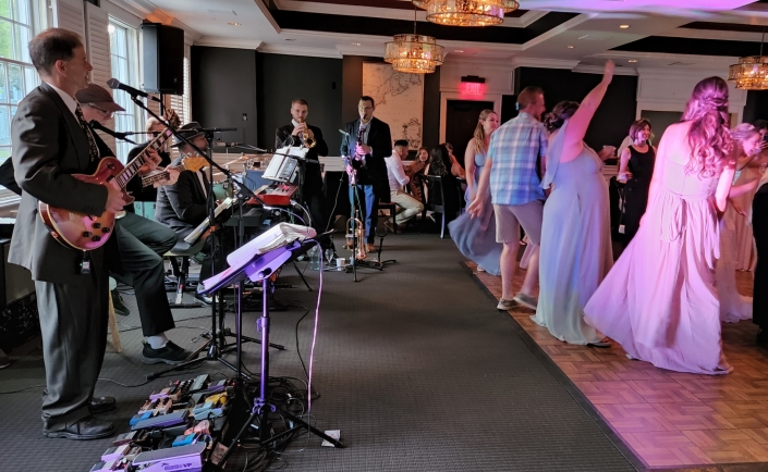 Wedding musician Dennis Winge playing with his band at a wedding ceremony.