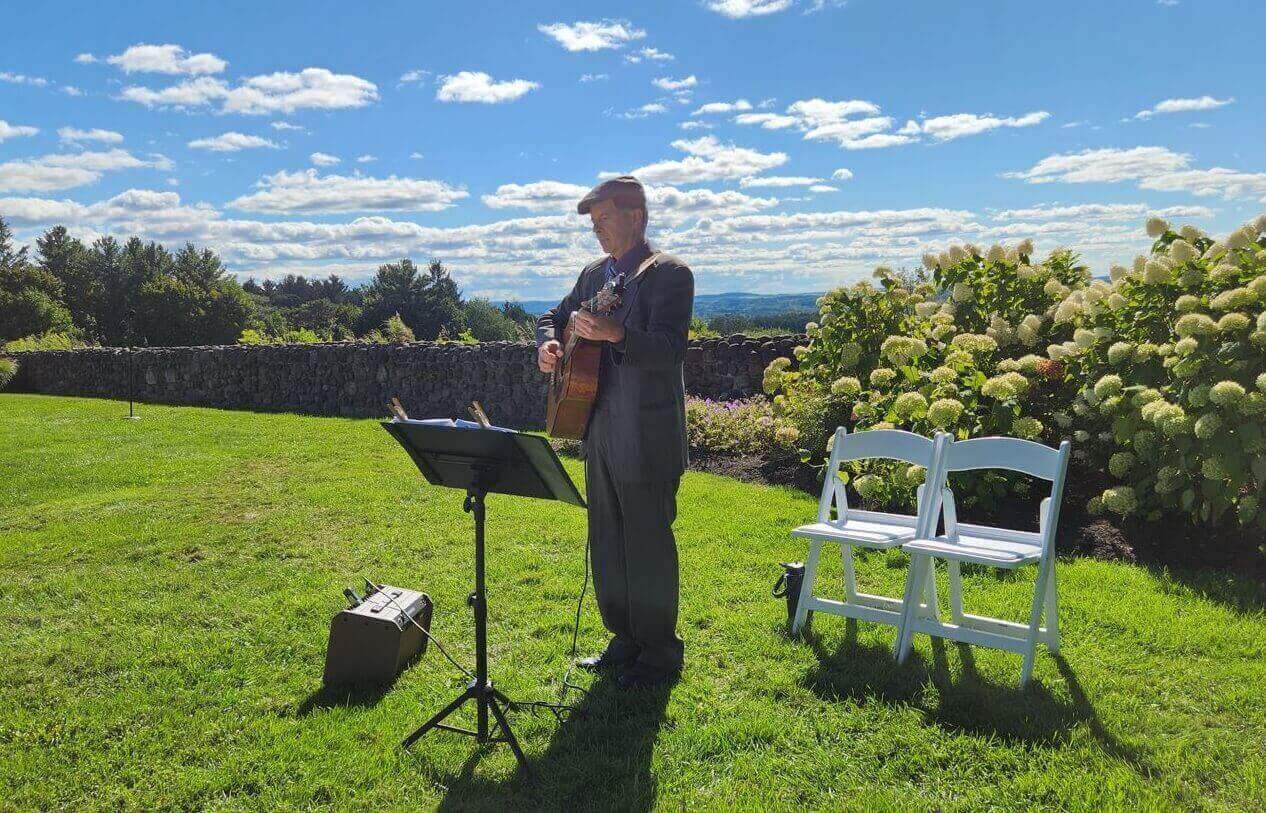 dennis-playing-wedding-ceremony-acoustic-guitar Dennis Winge playing acoustic guitar at wedding ceremony with beautiful view