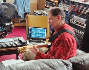 Dennis using midi guitar in recording studio