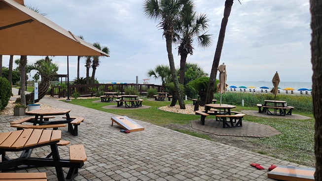 lawn games and beach view at beachfront kitchen & bar